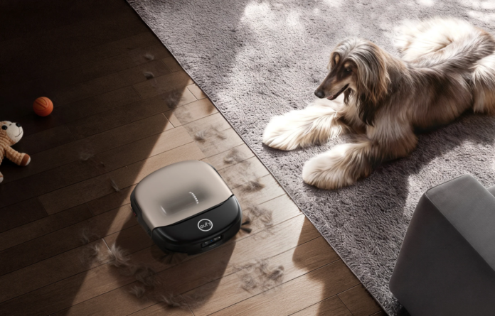 Robotic vacuum cleaning pet hair in a home with an Afghan Hound.