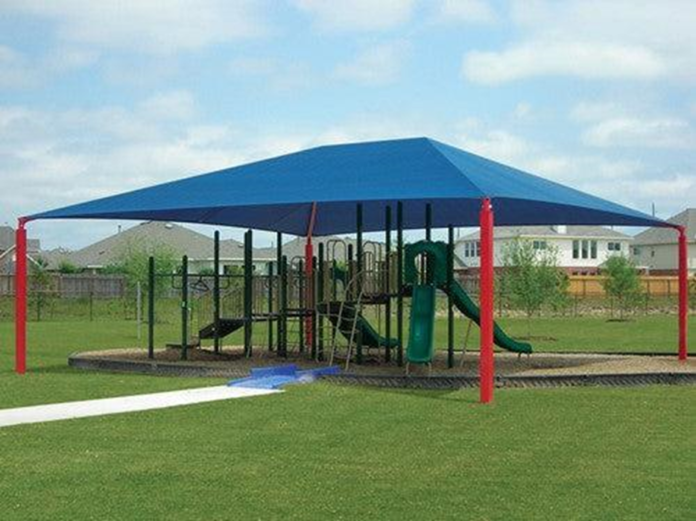 Playground covered by large blue shade structure.