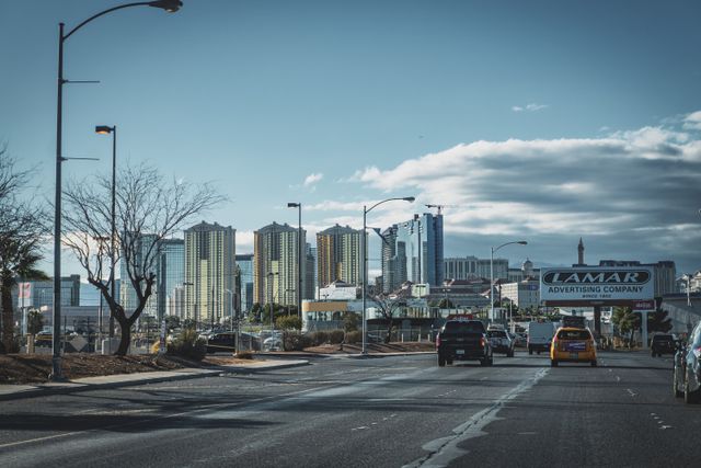 City skyline with high-rise buildings and traffic on an urban street.