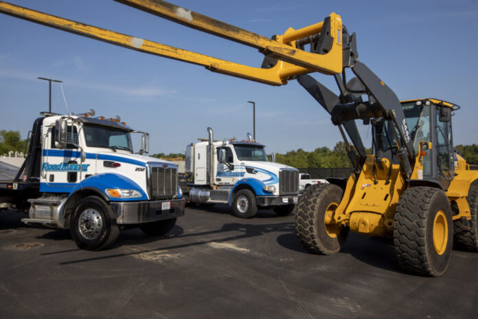 Heavy wrecker recovering a disabled semi truck on a highway